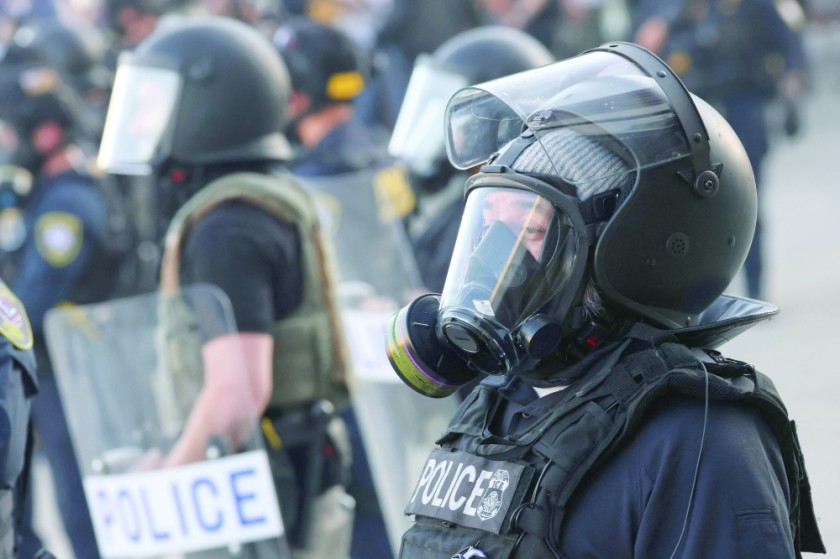 A law enforcement agent stands by during a 'National Shutdown' protest against US Immigration and Customs Enforcement in Los Angeles. - AFP