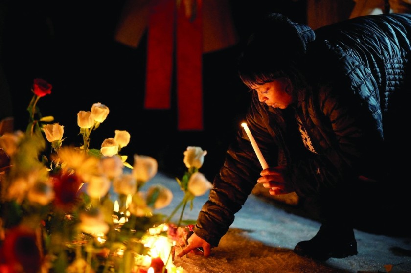 A woman reacts next to a memorial site during a vigil for a 37-year old woman who was shot in her car by a US immigration agent in Minneapolis, Minnesota. — Reuters