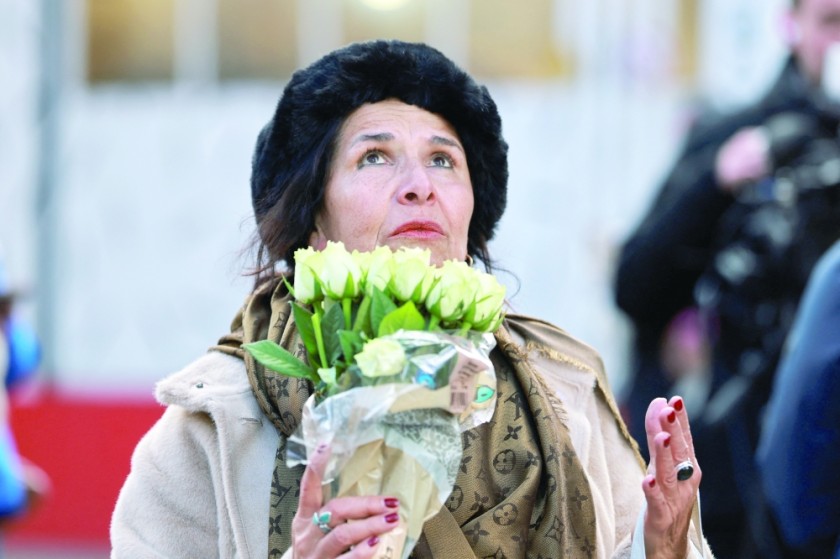 A woman reacts outside the 'Le Constellation' bar, after a fire and explosion during a New Year's Eve party where people died and others were injured, in southwestern Switzerland. — Reuters