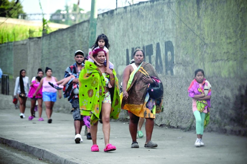 Civilians living inside Fuerte Tiuna, Venezuela's largest military complex, leave the place. — AFP