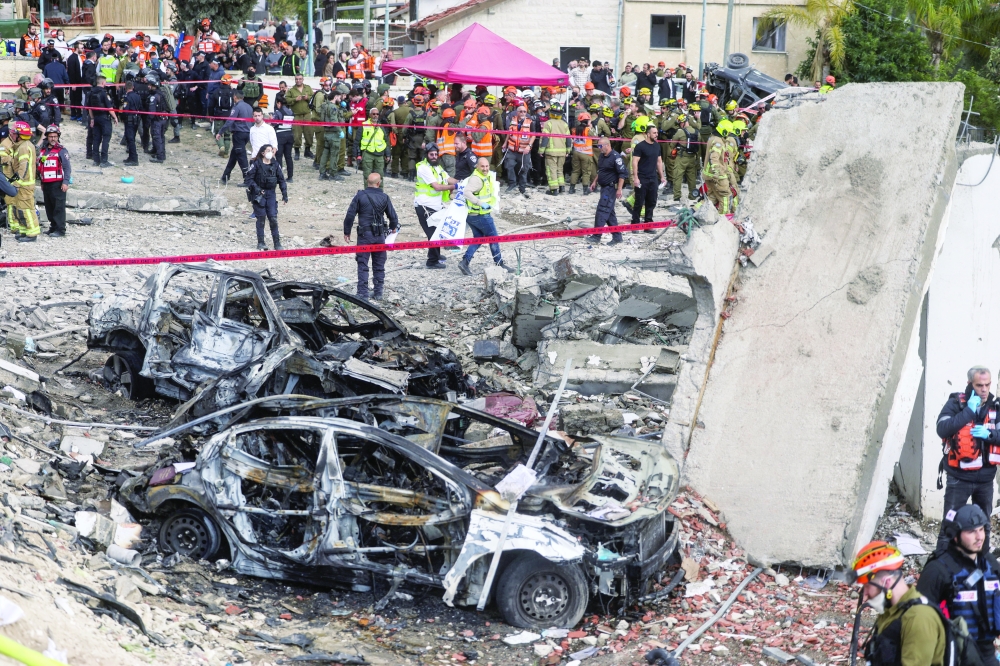 Emergency personnel work at the site of an Iranian strike, in Beit Shemesh, Israel. — Reuters