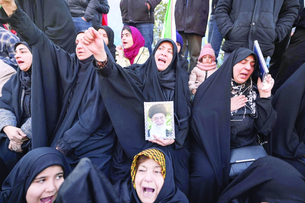 People mourn the death of Iran's supreme leader Ayatollah Ali Khamenei, at a square in Tehran. — AFP