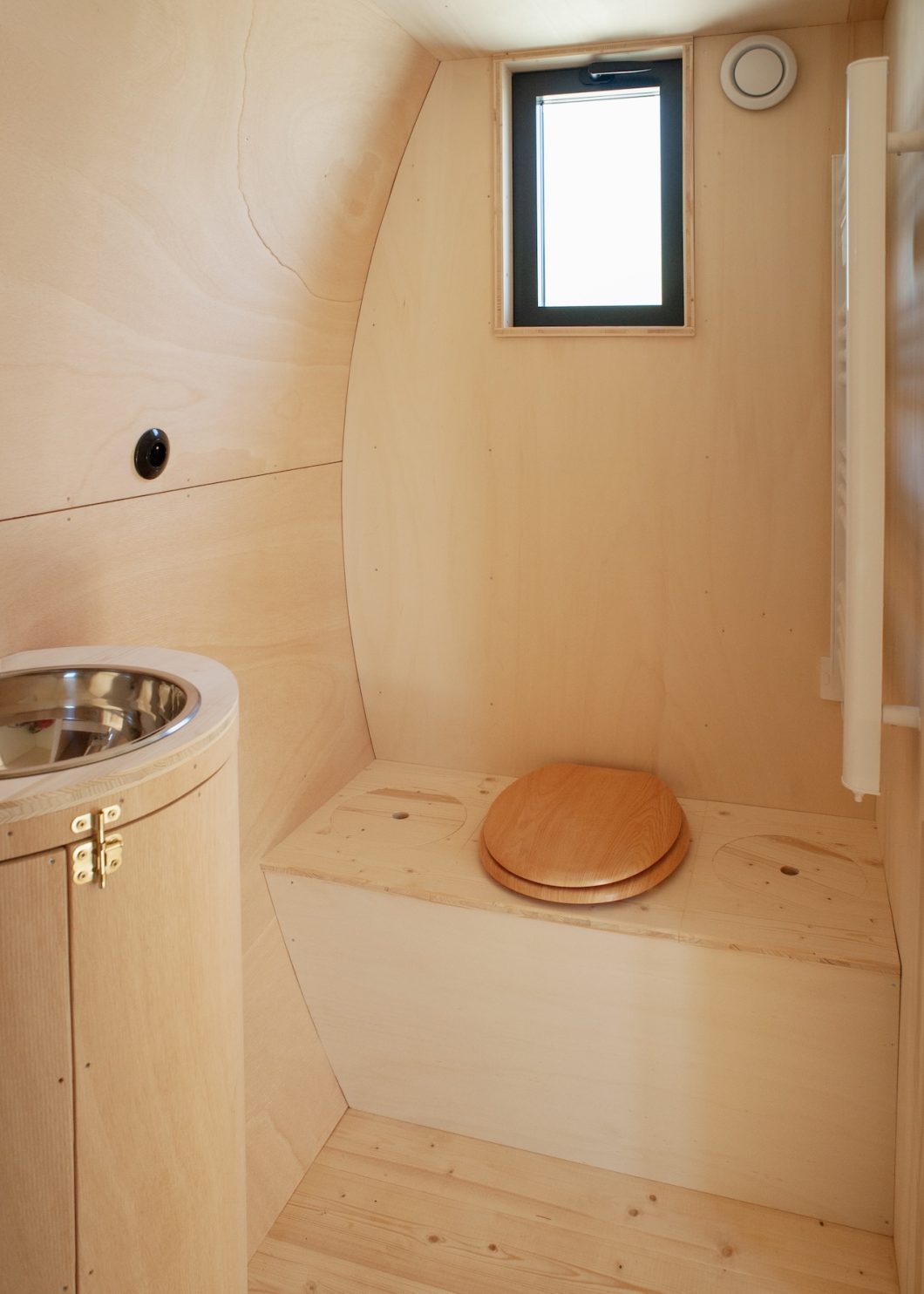 The bathroom is lined with plywood.