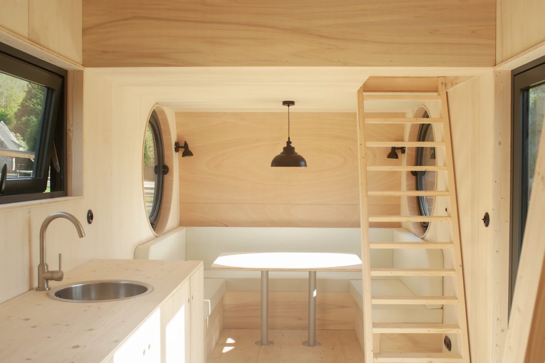 The living room serves as a relaxation area, dining room, study and additional bedroom.